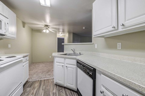 a kitchen with white cabinets and a sink